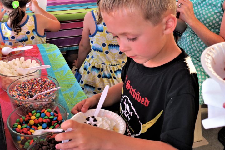 a young boy cutting a cake