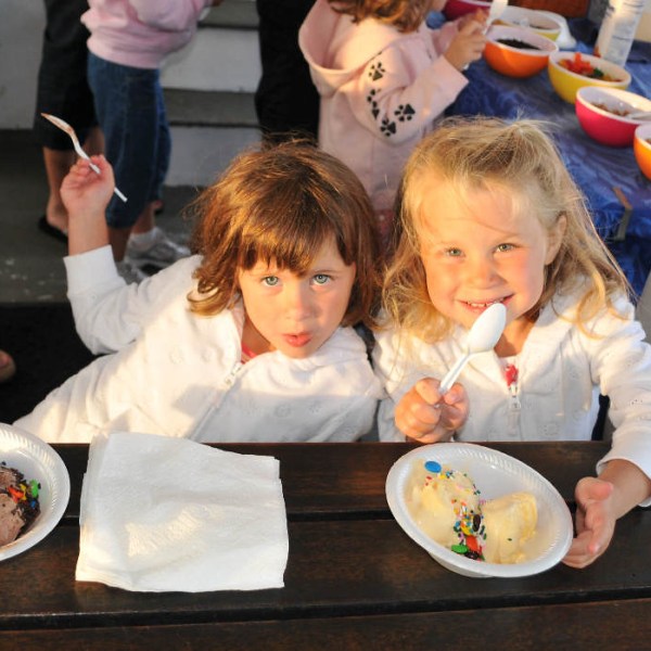 a group of people sitting at a table eating food