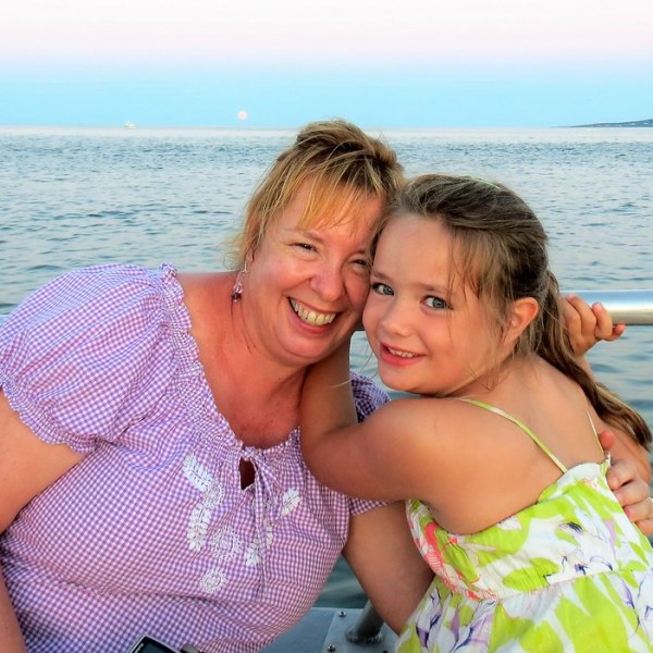 a person sitting next to a body of water