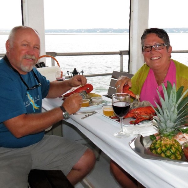 a group of people sitting at a table with a plate of food