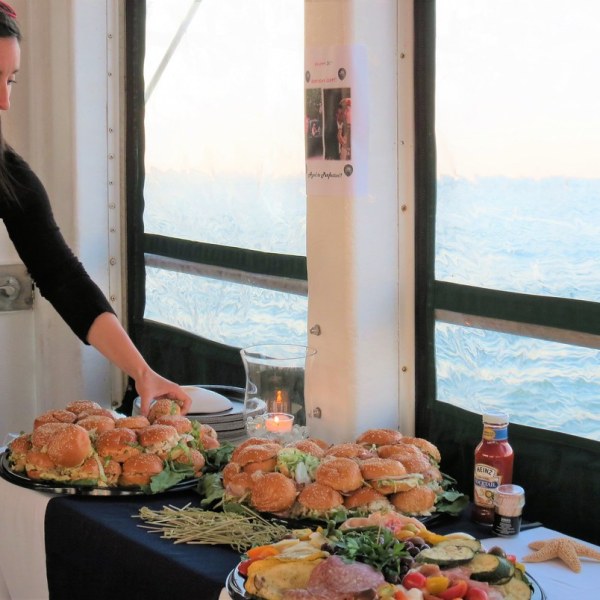 a woman standing in front of a plate of food