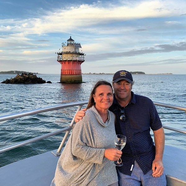a man standing next to a body of water