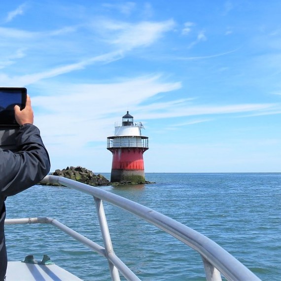 a man standing next to a body of water