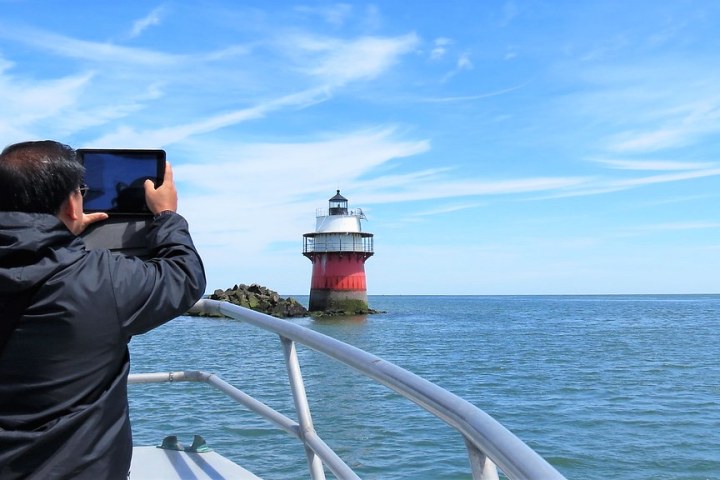 a man standing next to a body of water
