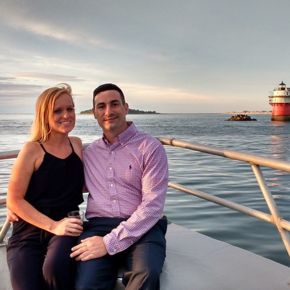 a person standing next to a body of water