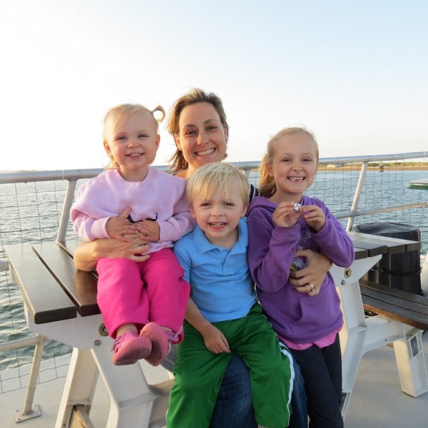 a little girl sitting on a table