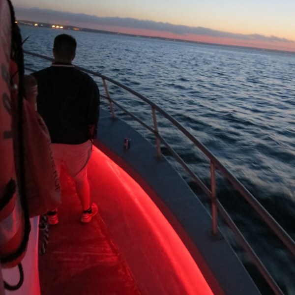 a group of people in a boat on a body of water