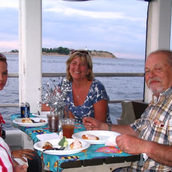 a group of people sitting at a table eating food