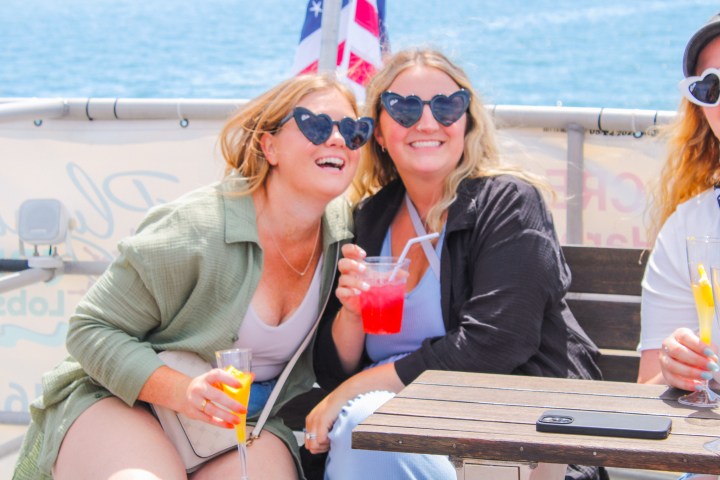 a woman in sunglasses sitting in a boat on the water