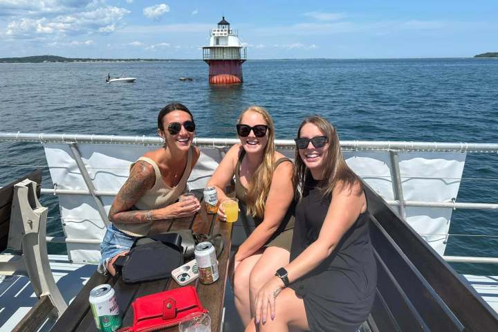a person sitting on a dock next to a body of water