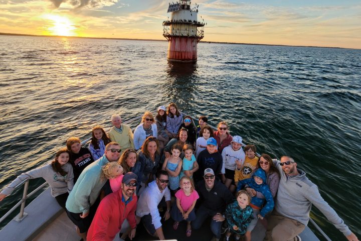 a group of people standing next to a body of water