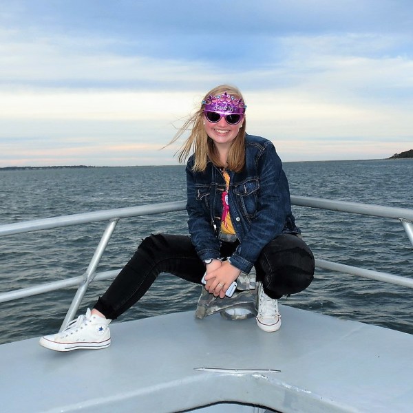 a person sitting next to a body of water