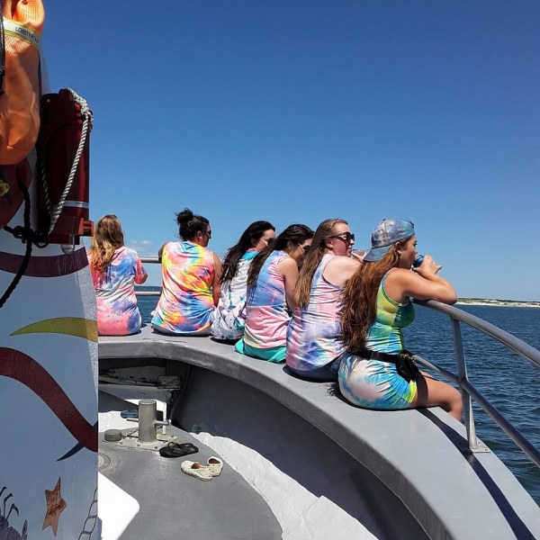 a group of people riding on the back of a boat