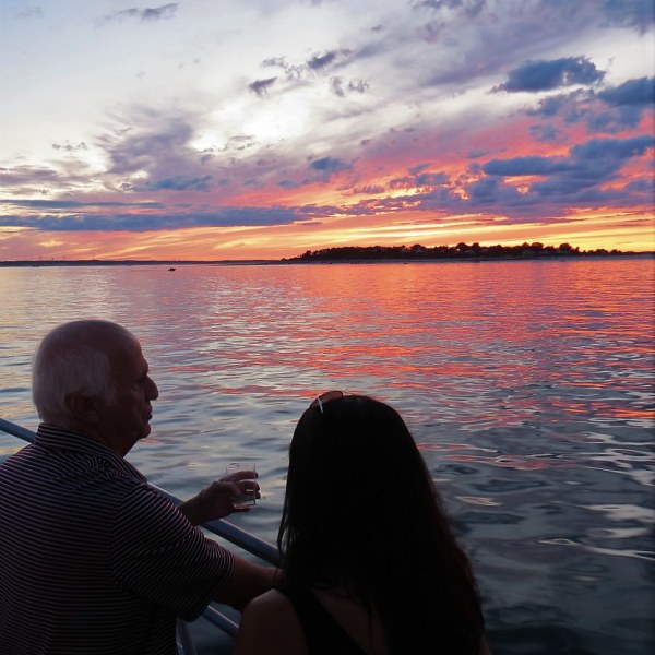 a man sitting in front of a body of water
