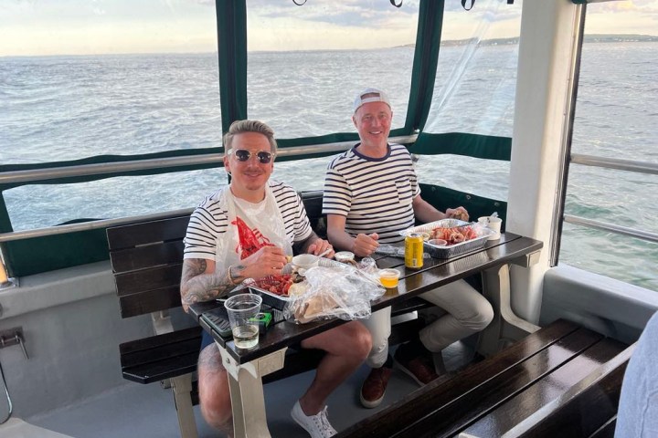 a man and a woman sitting on a boat in the water