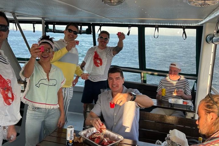 a group of people standing around a table